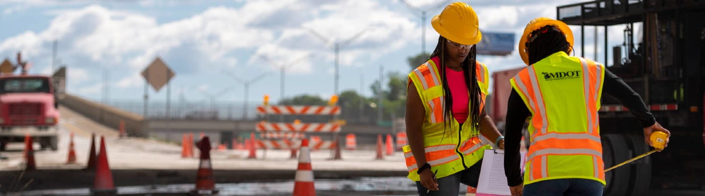 An employee takes measurements on the I-94 project in Jackson.