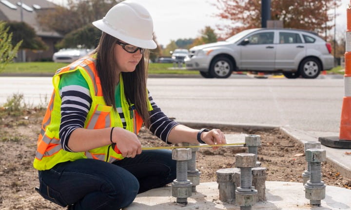 An MDOT Grand Region engineer takes measurements in a work zone.