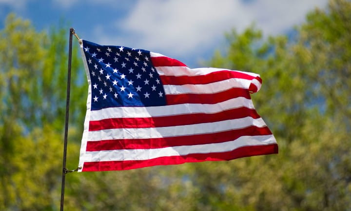 The American flag waving in the summer breeze.