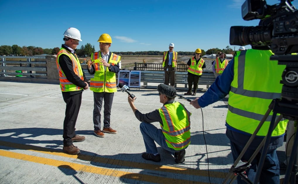State Transportation Director Bradley C. Wieferich and State Rep. Bill G. Schuette (95th District) talk to members of the media during an event to celebrate the opening of the M-30 bridge on Oct. 7.