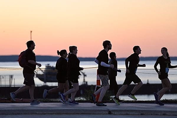 Participants in the Labor Day Mackinac Bridge Run at sunrise.