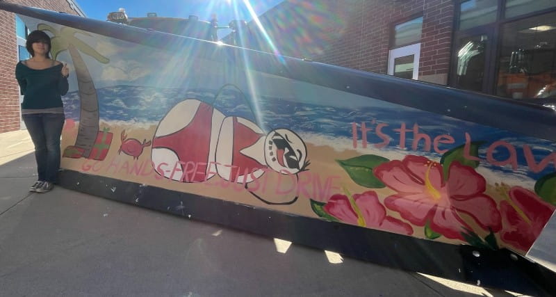 Caledonia High School senior art student, Josie D. Burns, proudly unveiled the school’s creative design for MDOT’s 2024-2025 Paint the Plow program.