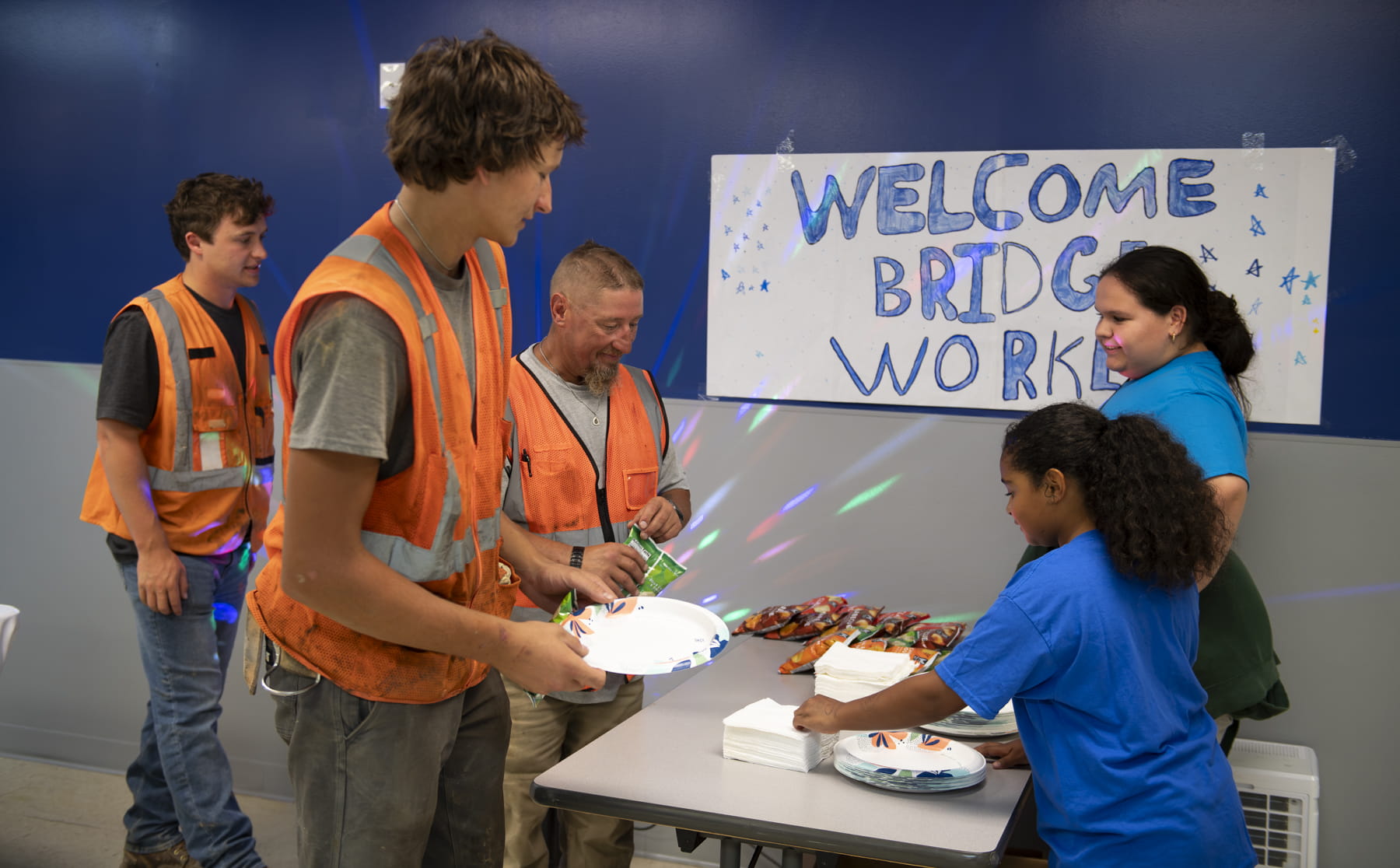 Workers from the Lafayette Street bridge demolition and rebuilding project interact with Boys and Girls Club Torch Club members during a lunch event on Monday, July 28.