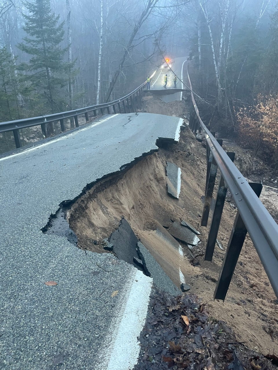 Damage to bridge and road from a culvert washout, slope failure closes M-119 in Emmet County