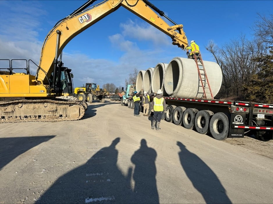 Segments of concrete pipe are being prepared to be installed on M-20 in Isabella County to temporarily replace the failed culvert.