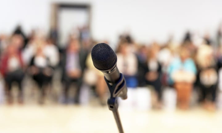 Public meeting with a microphone.