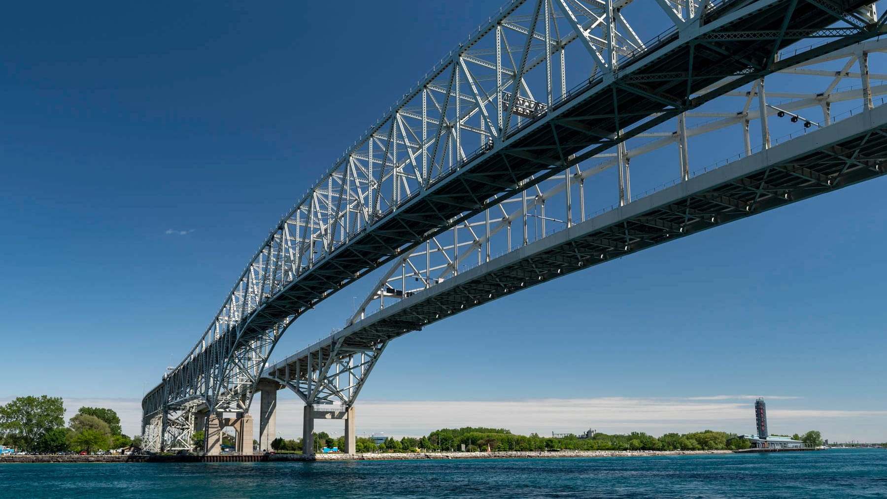 An an ore boat passing underneath the Blue Water Bridge.