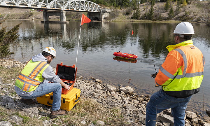 Chad Skrocki and Brandon Boatman inspecting bridge with EMILY