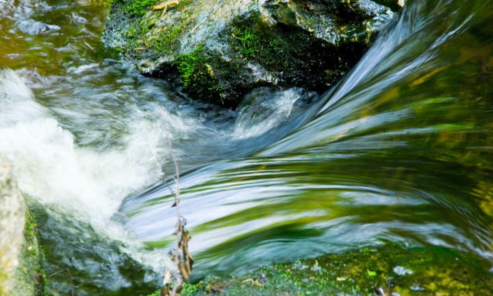 Steam cascading over rocks.