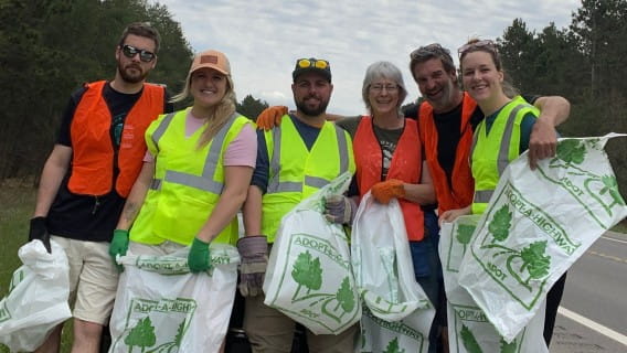 AAH volunteers pose for a photo before picking up litter from the highway.
