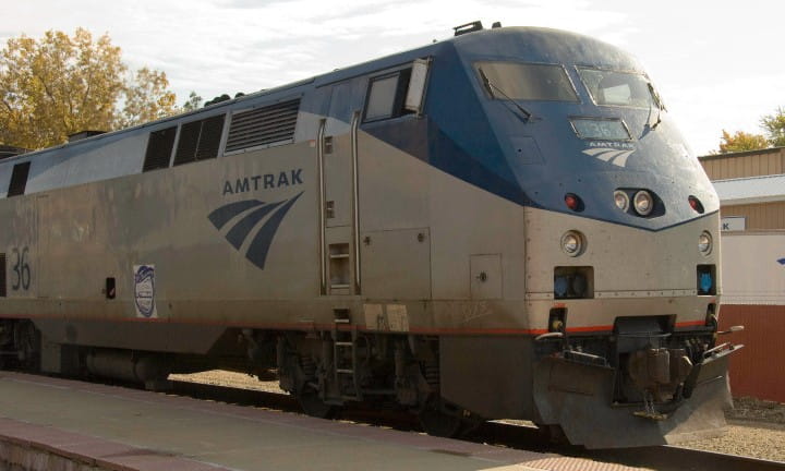 Amtrak passenger train sitting on the tracks.