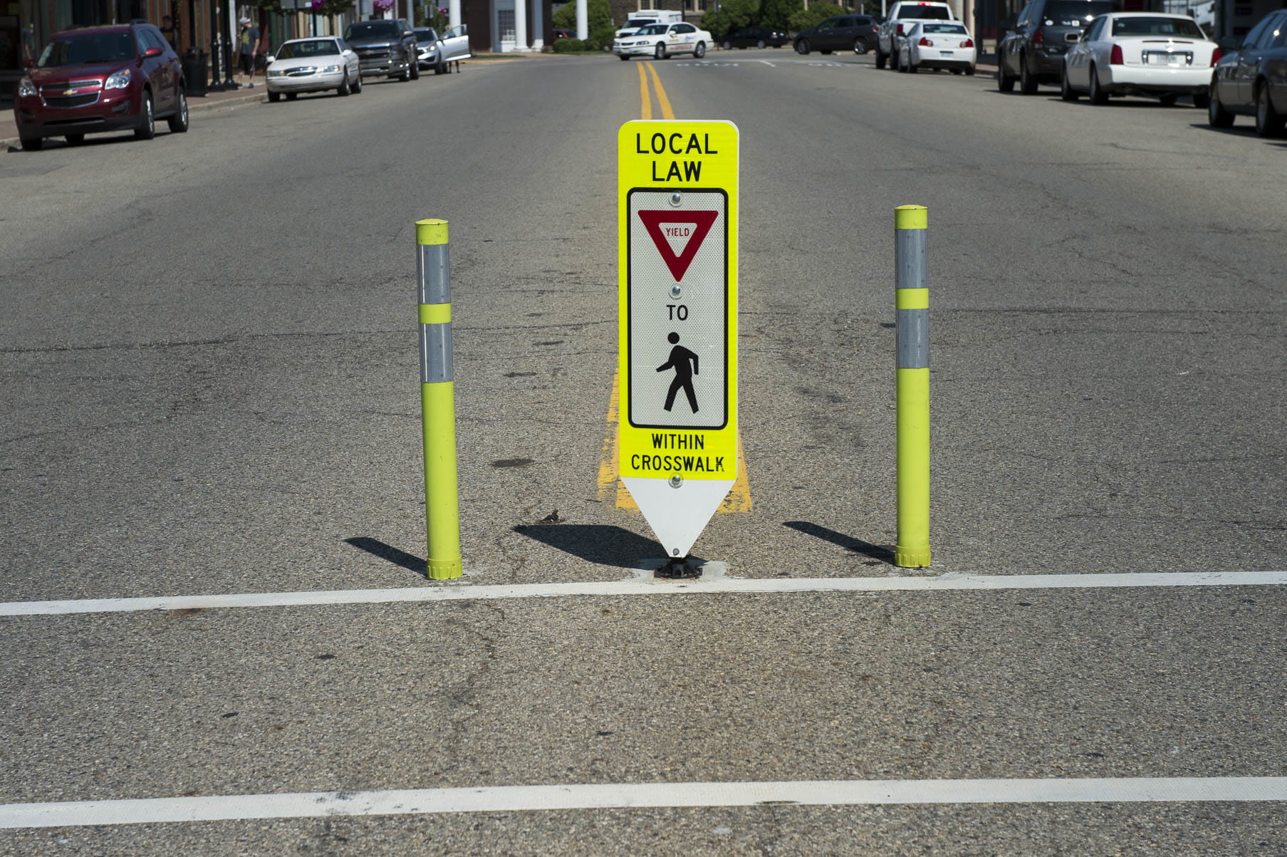 Gateway crossing sign showing yield sign for pedestrians crossing. 