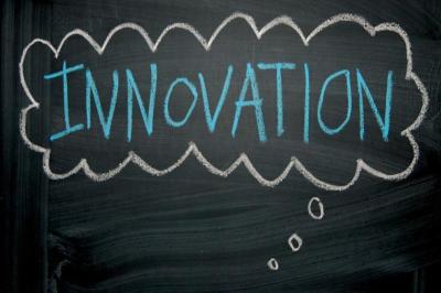 Innovation written on a chalkboard with a thought bubble drawn around it.