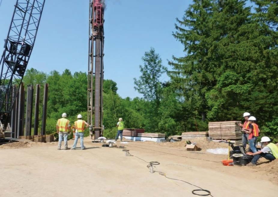 Researchers used sensors (shown in foreground, connected via cables) to measure vibrations at various distances from pile driving operations, both on the surface and at various depths.