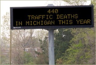 Dynamic message sign displaying crash facts; this sign reads 440 traffic deaths in Michigan this year.