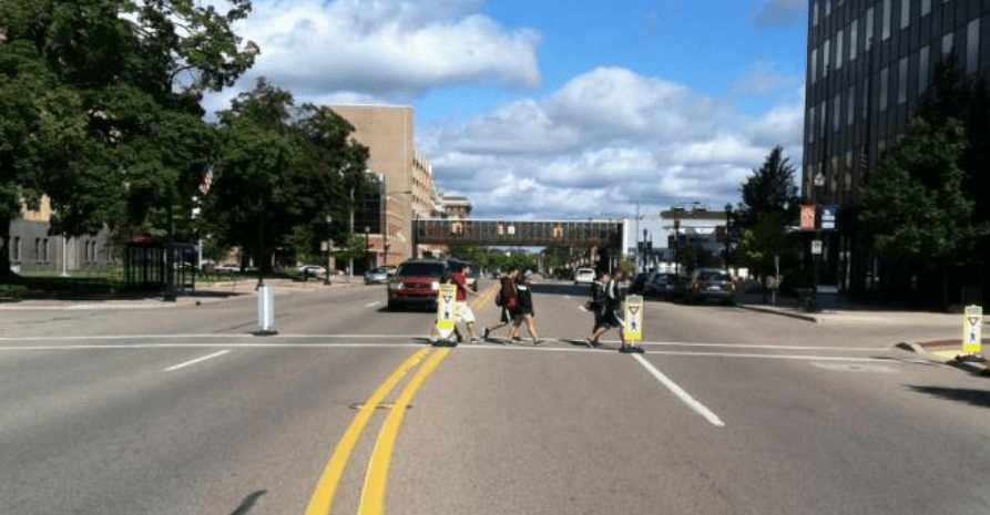 Pedestrians using a gateway crossing to cross road. 