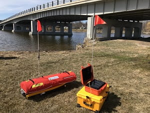 A modified Emergency Integrated Lifesaving Lanyard robotic boat with its control box. 