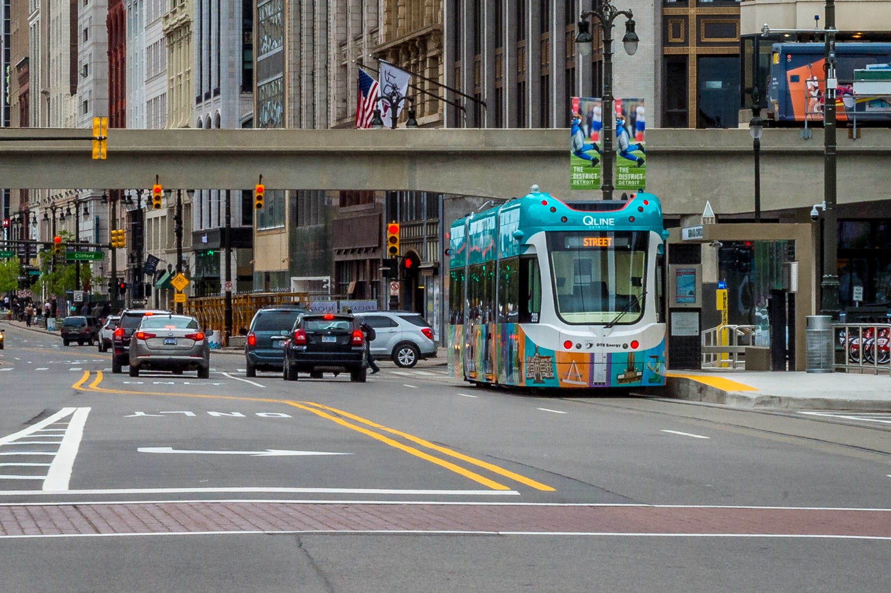 A QLINE streetcar at a passenger stop on the Woodward Corridor in downtown Detroit.