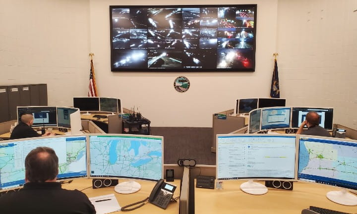 MDOT's Statewide Transportation Operations Center with staff monitoring traffic and incidents through computers and TVs mounted on the wall.