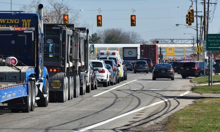 A view of M-85 (Fort Street) traffic backed up waiting for a Canadian National (CN) train to pass.