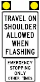 A flex route designed sign with yellow lights and information that reads, "Travel on shoulder allowed when flashing. Emergency stopping only other times."