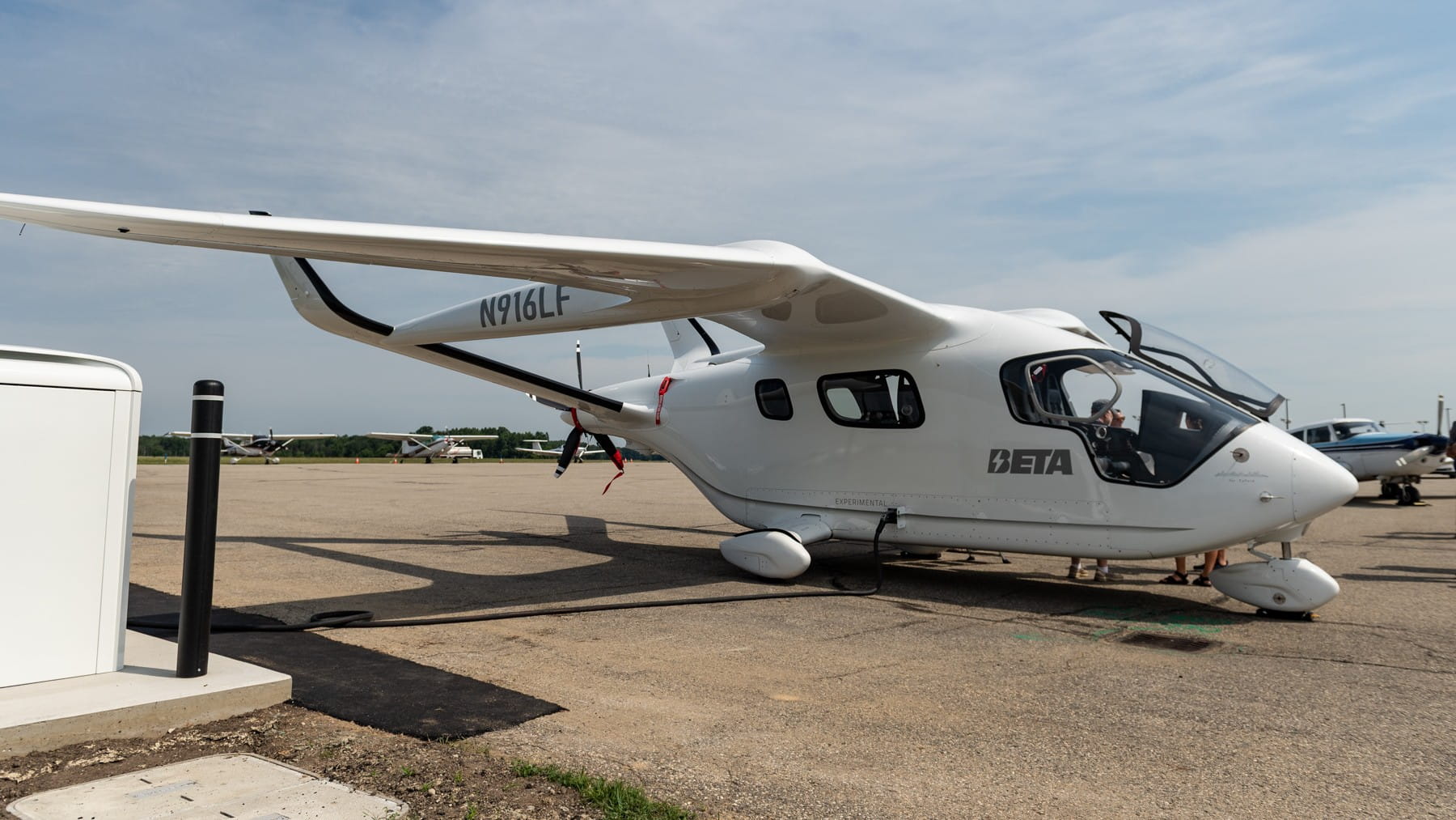 An electric aircraft charging at an airport.