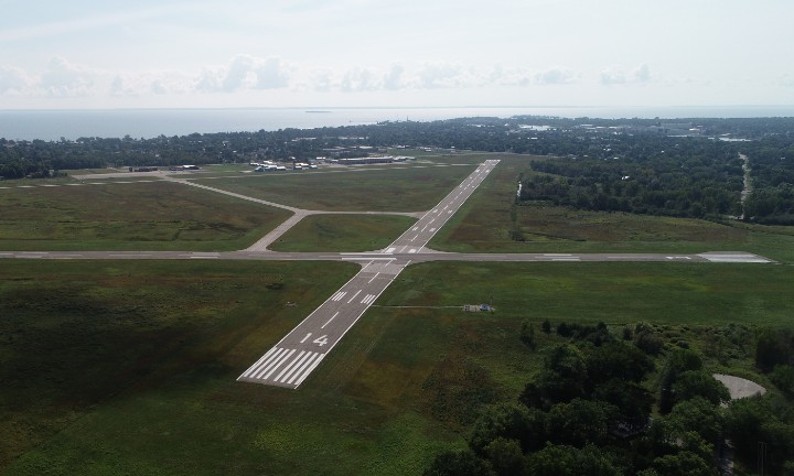 An airport runway in green grass.