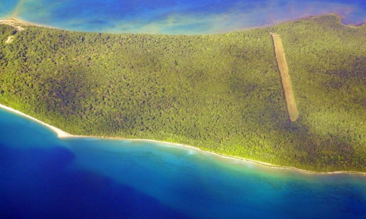 A landing strip surrounded by water.