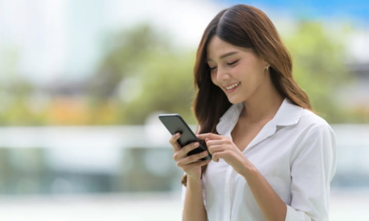 A woman using her mobile phone.