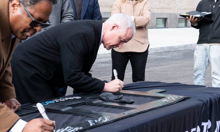 MDOT Director and Deputy City Of Detroit Mayor sign inductive coil and unveil the nation's first public EV-charging roadway at Michigan Central on 14 Street.