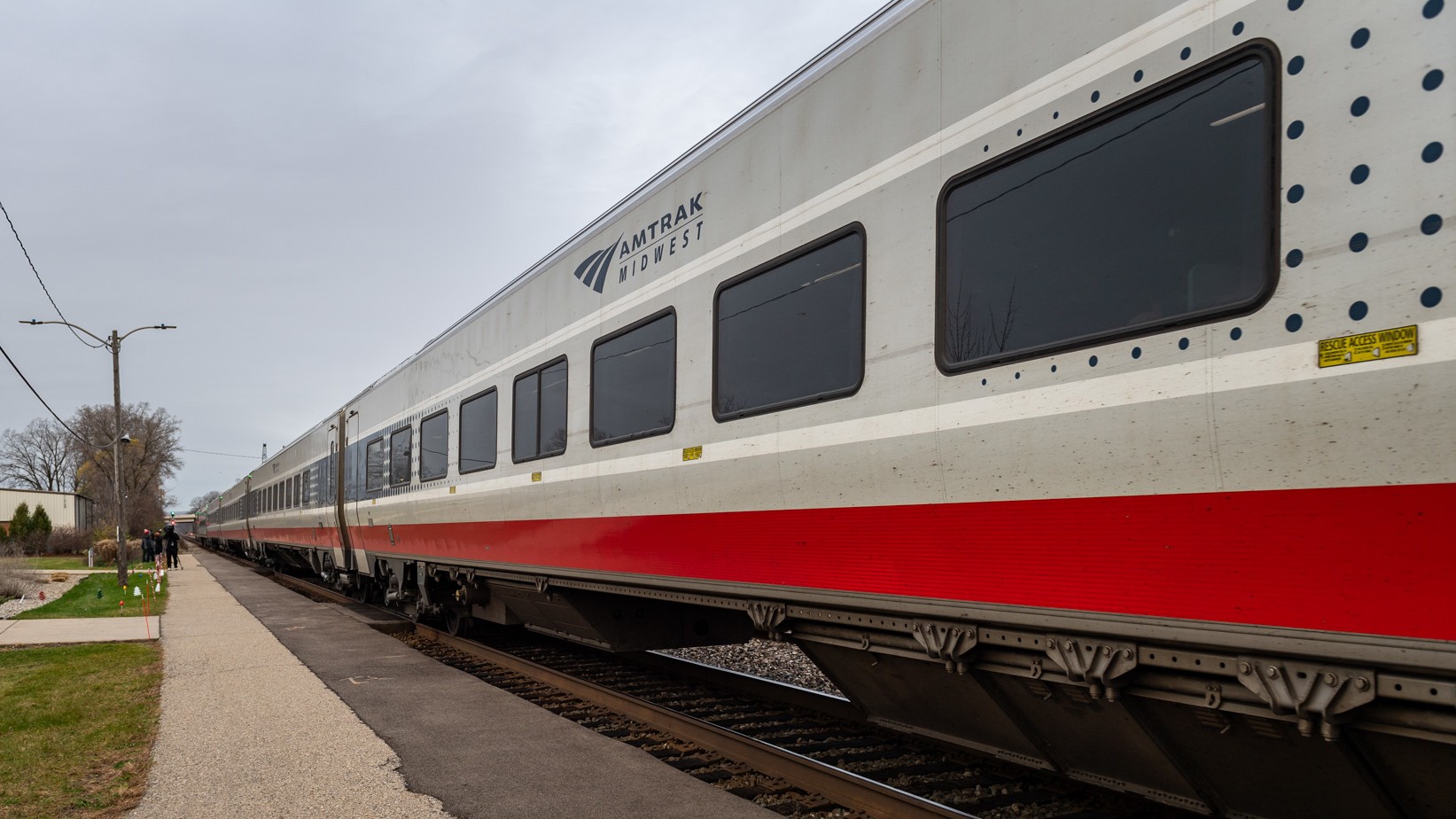 Amtrak cars wait at a station.