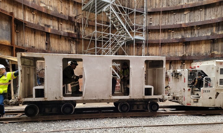At the base of the tunnel, crews wait on the train trolley to take them further inside to do work.