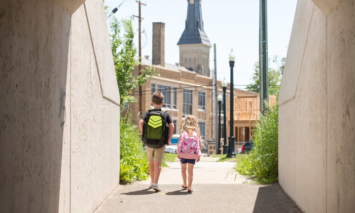 Children walking through a pedestrian tunnel in Grand Rapids.