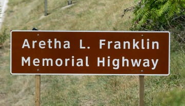 A memorial sign showing the designation of the Aretha L. Franklin Memorial Highway.