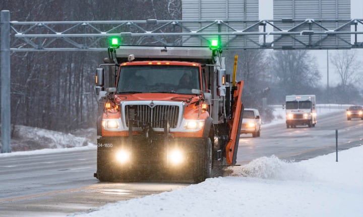 Winter maintenance vehicles with traffic on I-96 and I-496 in Eaton County.