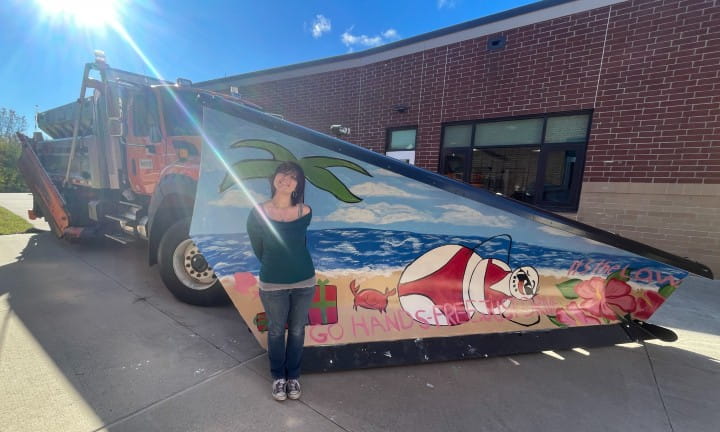 Caledonia High School senior art student, Josie D. Burns, proudly unveiled the school’s creative design for MDOT’s 2024-2025 Paint the Plow program.