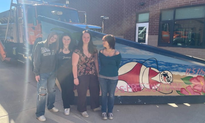 Caledonia High School students stand next to their painted plow blade.