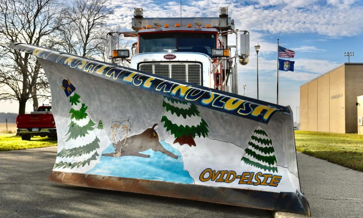 Ovid-Elsie High School art students introduced their safe winter driving-themed plow blade - Don't Rush in Ice and Slush.