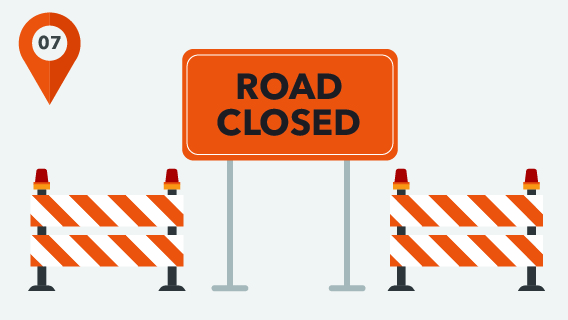 A graphic with a road closed sign and work zone barricades.