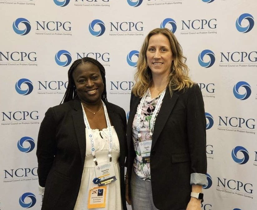 2 people standing in front of NCPG backdrop