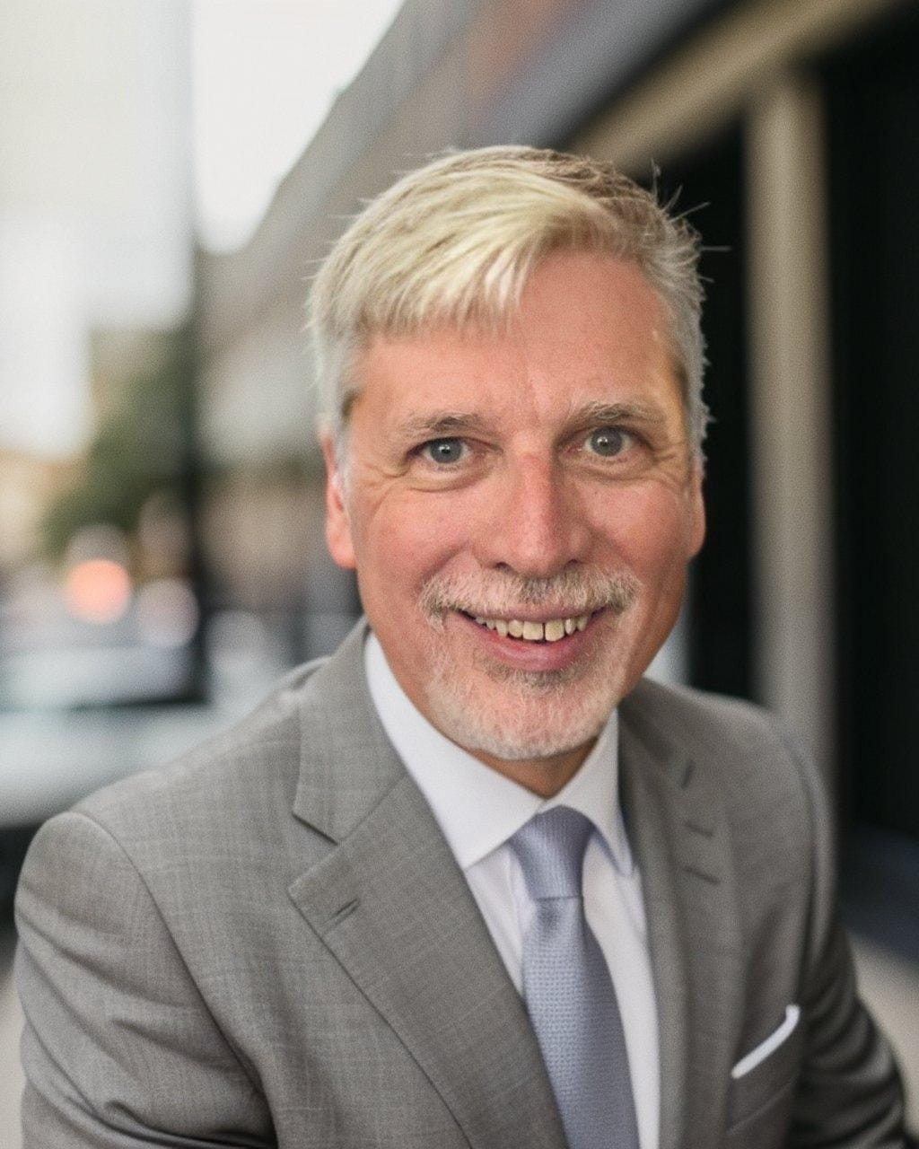 Headshot of Kelvin L. Meyers in a gray suit smiling.