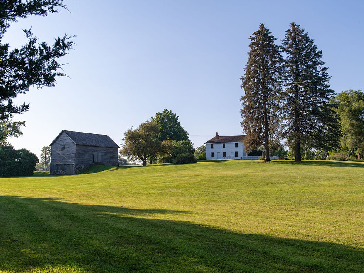 Walker Tavern and barn on a summer morning