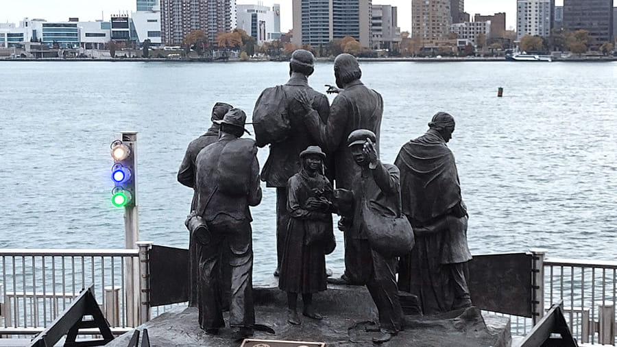 Monument in Detroit depicts the Gateway to Freedom and features a bronze sculpture of six Underground Railroad travelers awaiting transport to Canada