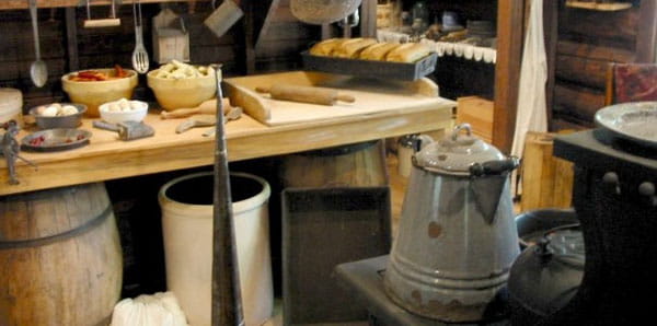 Bowls, rolling pin, stove and cooking supplies in the cooking area of the logging museum at Hartwick Pines State Park.