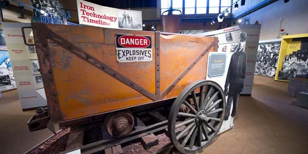 A large mining rail car in a museum exhibit