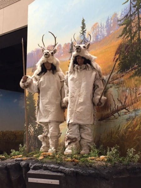 Two figures representing Paleo Indian hunters on newly fabricated landform model.
