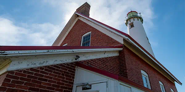 Looking up at the side and tower of the Tawas Point Lighthouse.