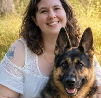 Survivor, Robin Bolz sitting outside next to her German Shephard dog. Photo shared with permission from Robin.