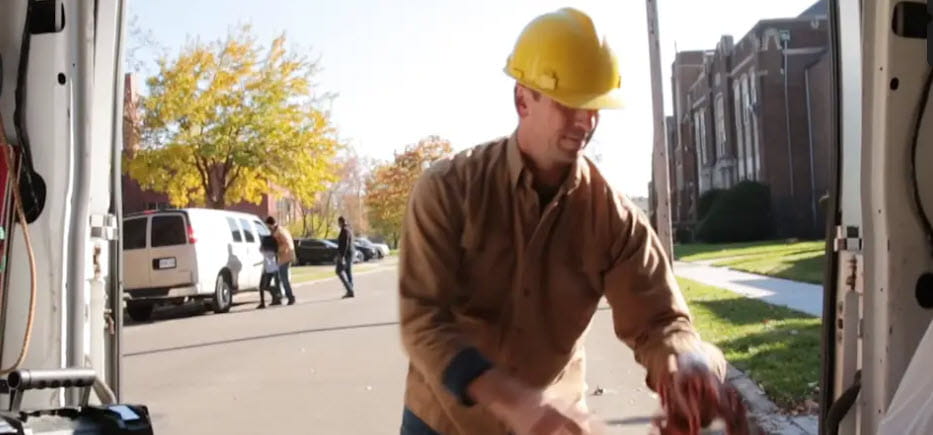 Male worker on a job site with a yellow hard hat