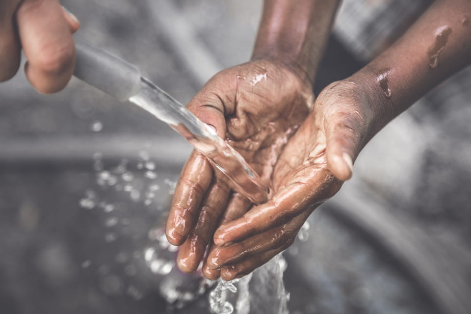 Water pouring into open hands